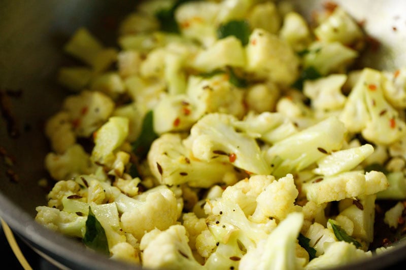 cauliflower florets mixed with tempered ingredients.