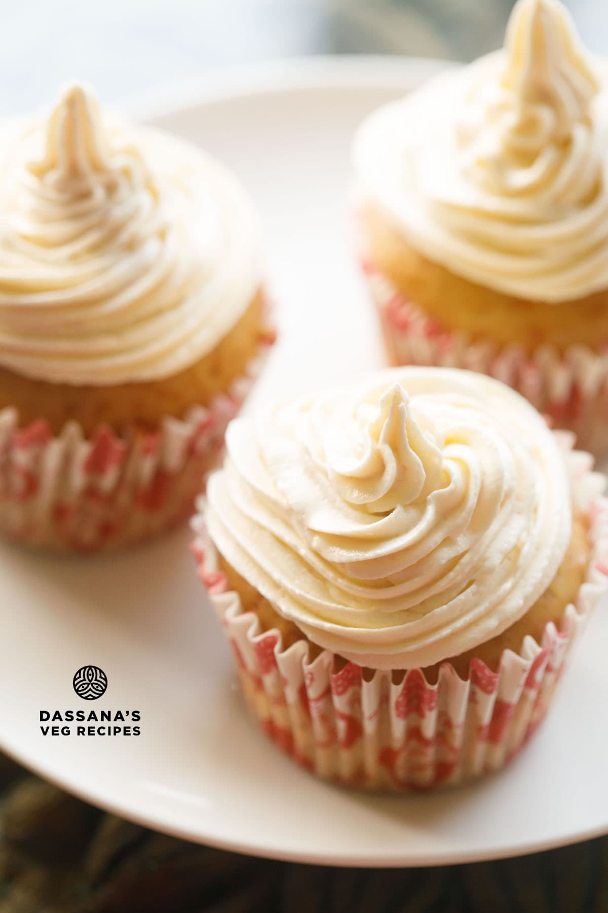 closeup image of three eggless cupcakes frosted with buttercream icing with text layovers.