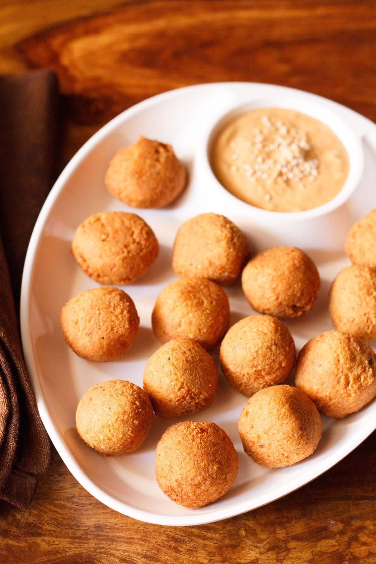 falafel served in a chip and dip platter with muhammara.