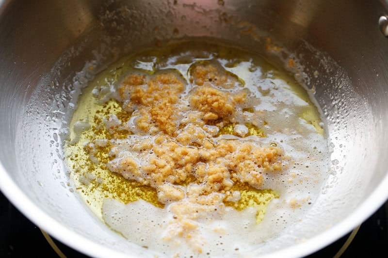 golden fried garlic with butter in pan.