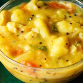 closeup image of puri curry in a bowl.