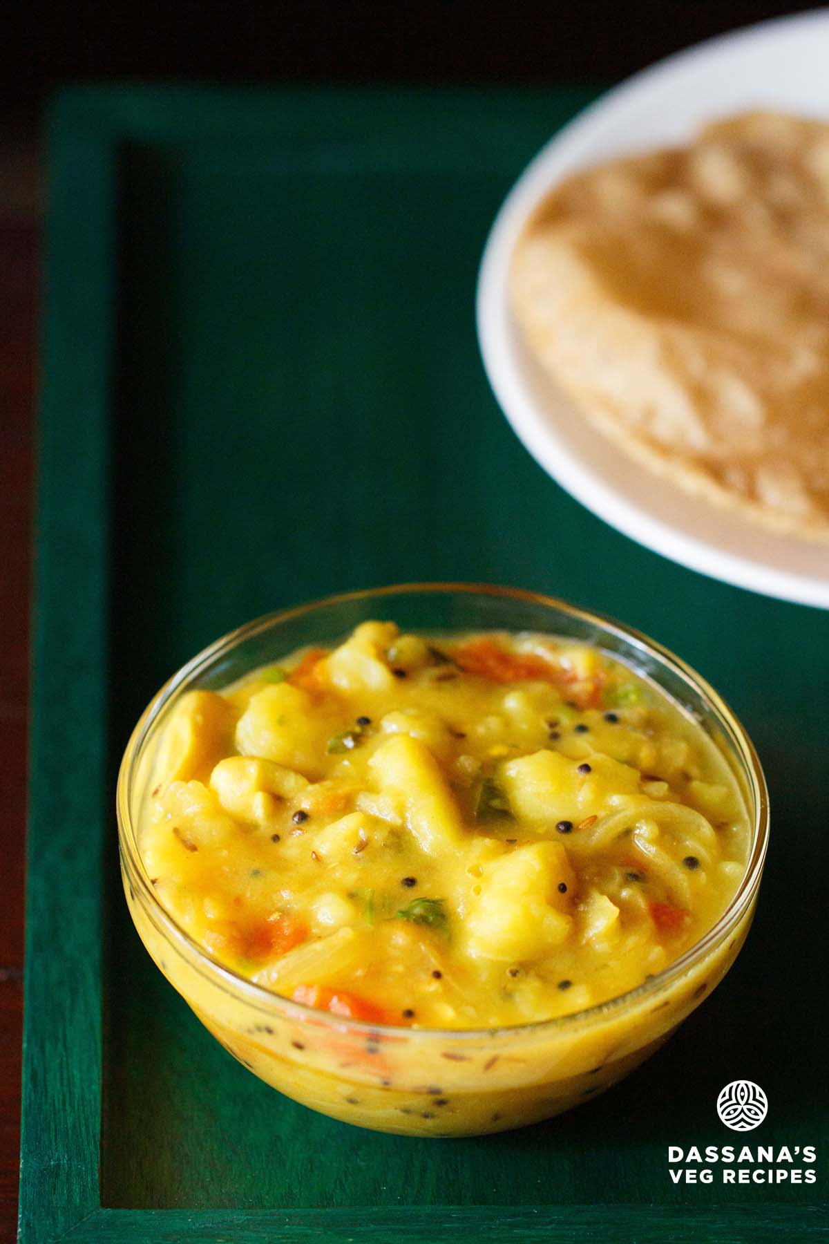 poori masala also called poori curry; this combination served on green tray.