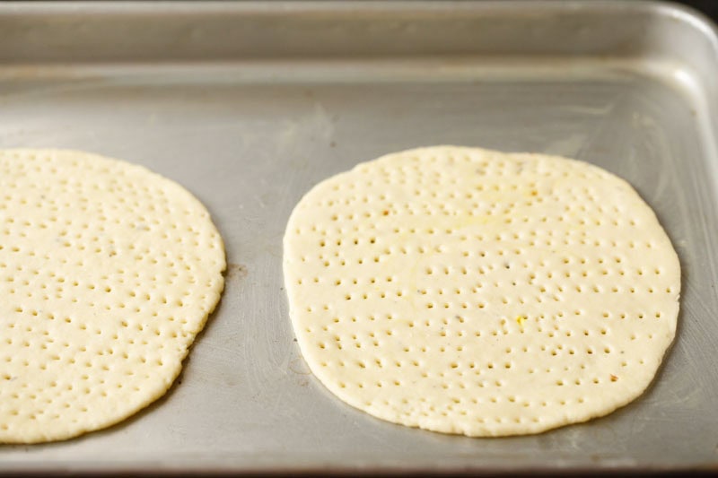 rolled discs on a baking tray.