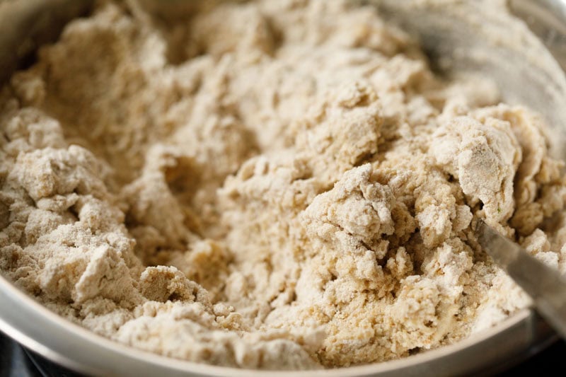 flour, urad dal paste, seasonings being mixed to form a dough for bedmi puri recipe.