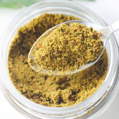 curry leaves powder in a spoon.