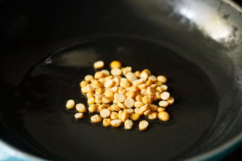 raw chana dal in skillet.