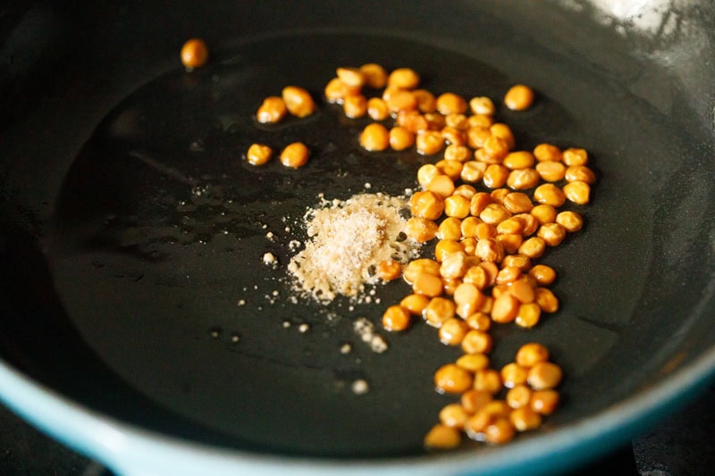 a small tiny mound of asafoetida (hing) in skillet with the roasted chana dal.