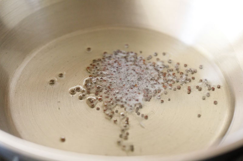 mustard seeds crackling in sesame oil in a wok.