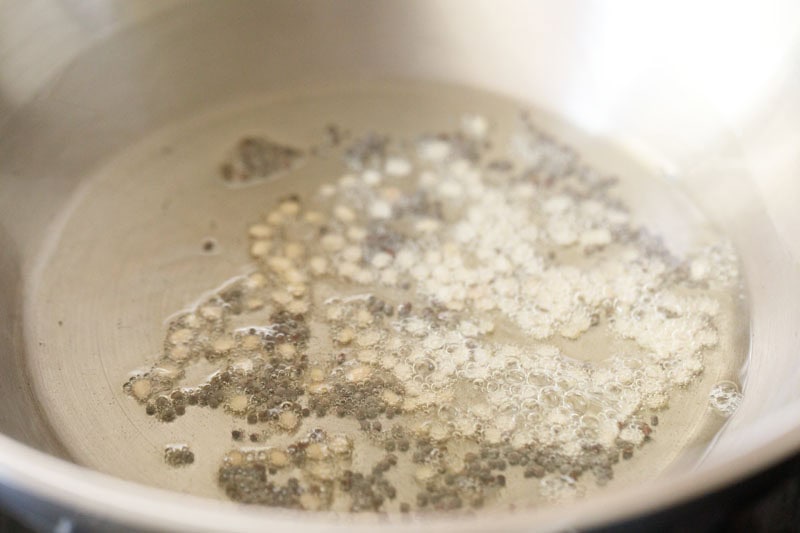 urad dal and mustard seeds in the wok or kadai.