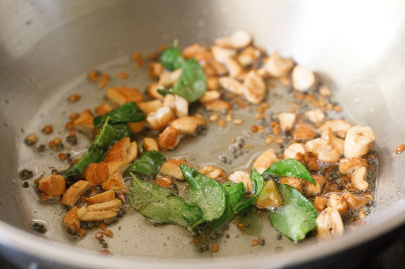 curry leaves and asafoetida mixed with cashews and spices.