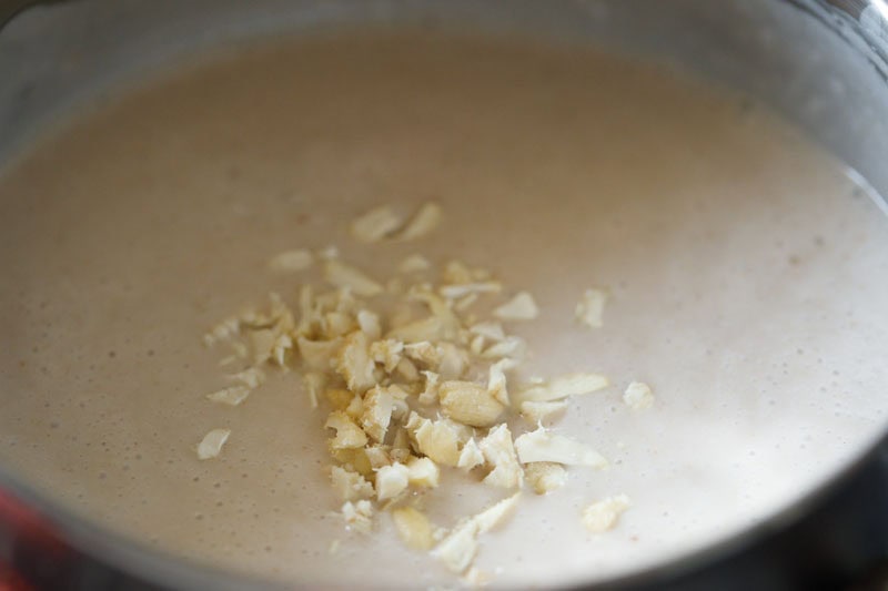 chopped cashews on top of elaneer payasam in the bowl.