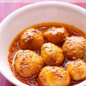 kashmiri dum aloo served in a white bowl with text layovers.