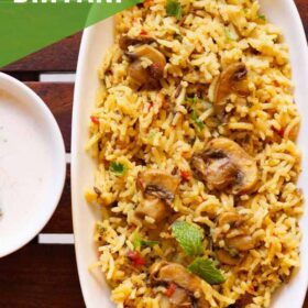 overhead shot of mushroom biryani in an oblong white tray on a wooden board with text layovers.