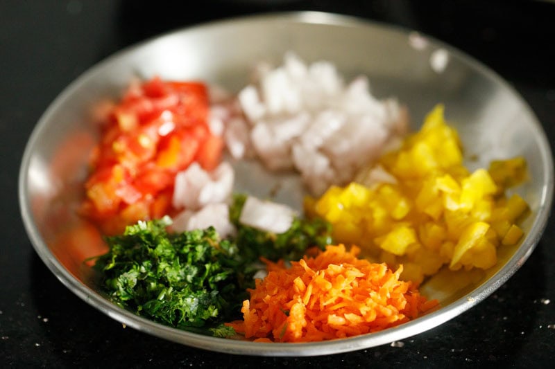 vegetables and herbs on plate to make paneer dosa.