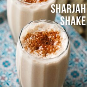 sharjah shake in 2 glasses sprinkled with bournvita on a blue design tray with text layovers.