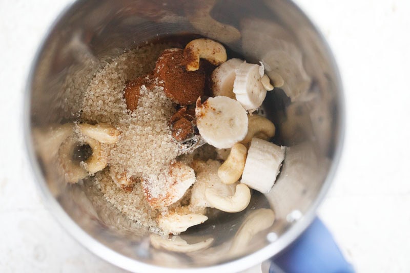 chopped bananas, sugar, bournvita, cashews in a blender.