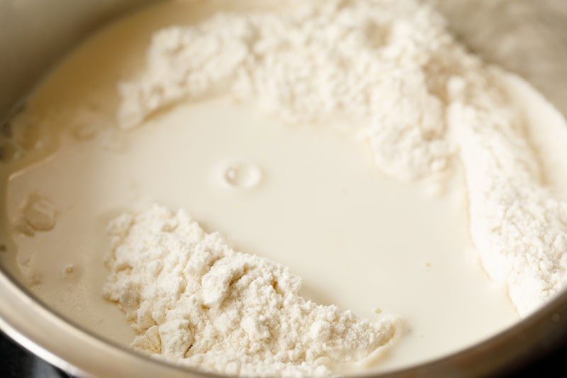 milk floating on flour in mixing bowl.