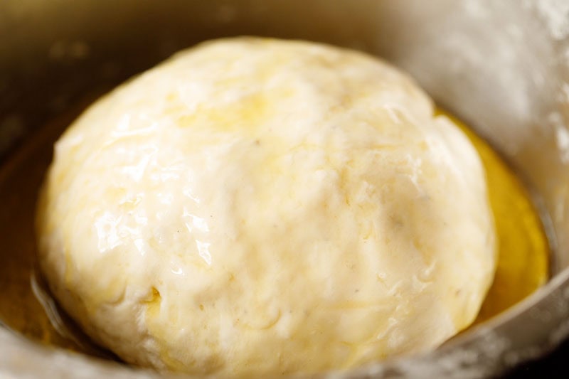 ghee coated shirmal dough ball in bowl.