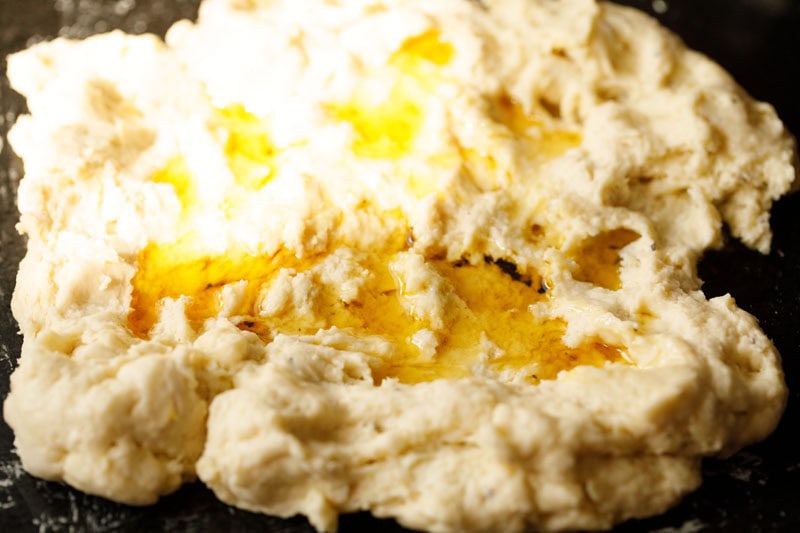 ghee floating on spread shirmal dough with the indents.