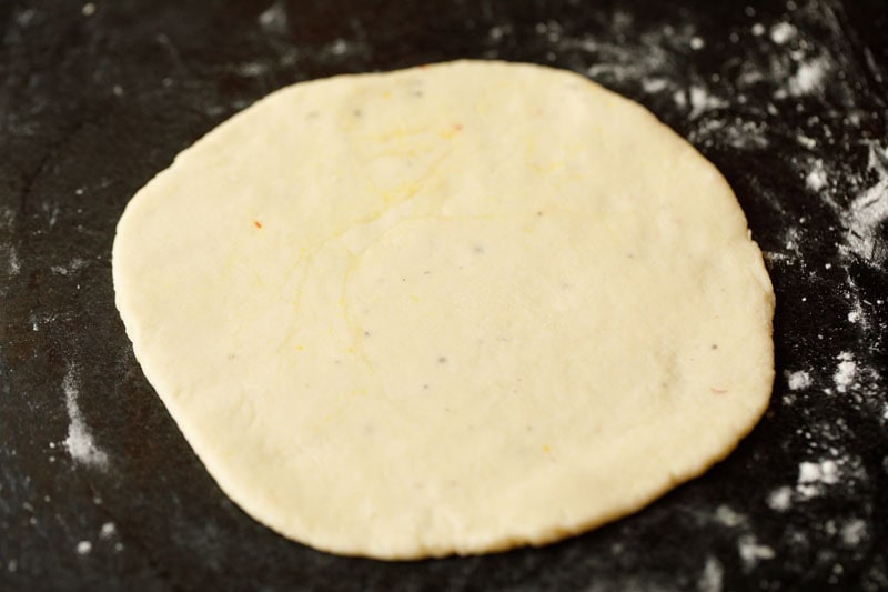 rolled sheermal bread dough on a lightly flour sprinkled countertop.