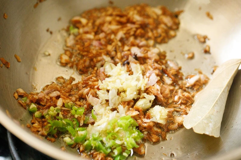 ginger-garlic paste and green chillies on top of the browned onions.