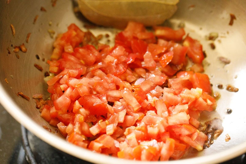 chopped tomatoes in pan.