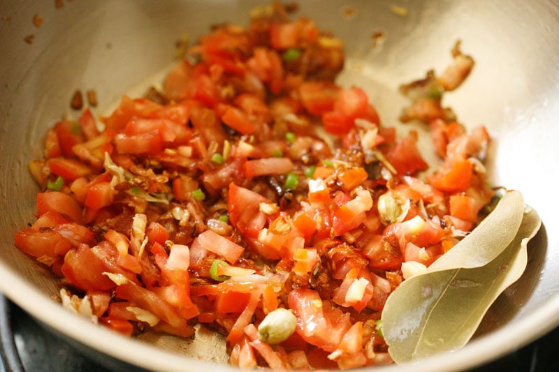 chopped tomatoes mixed in pan.