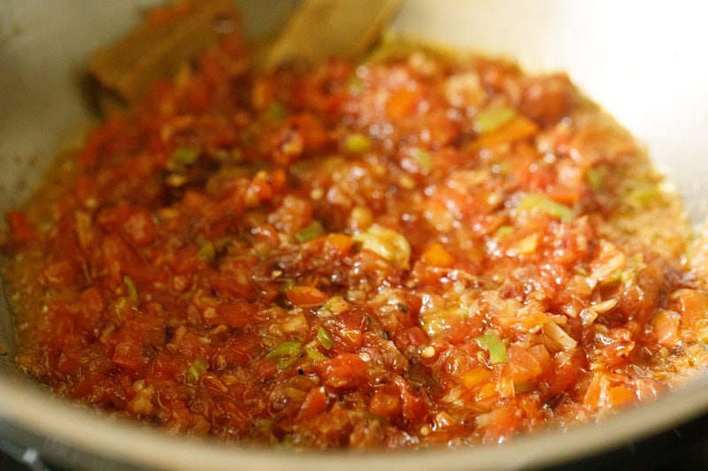 softened and mushy sautéed tomatoes in pan.