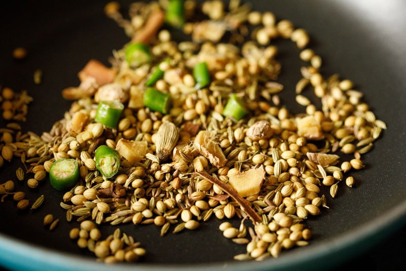 green chillies, ginger added to whole spices in the skillet.