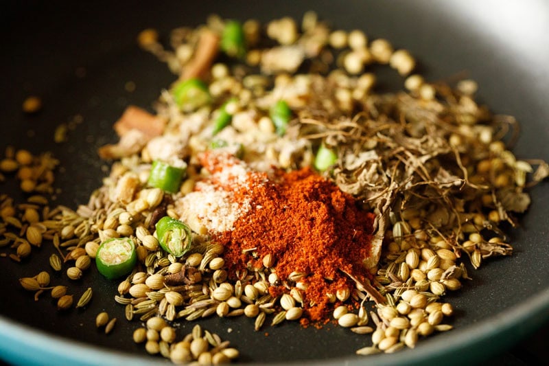 ground spices and herbs added to the roasted spices in skillet.