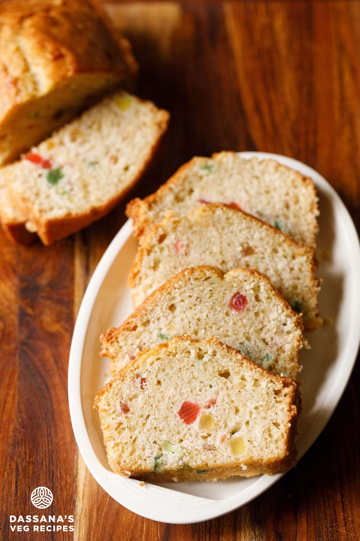 tutti frutti cake slices served on a white platter.