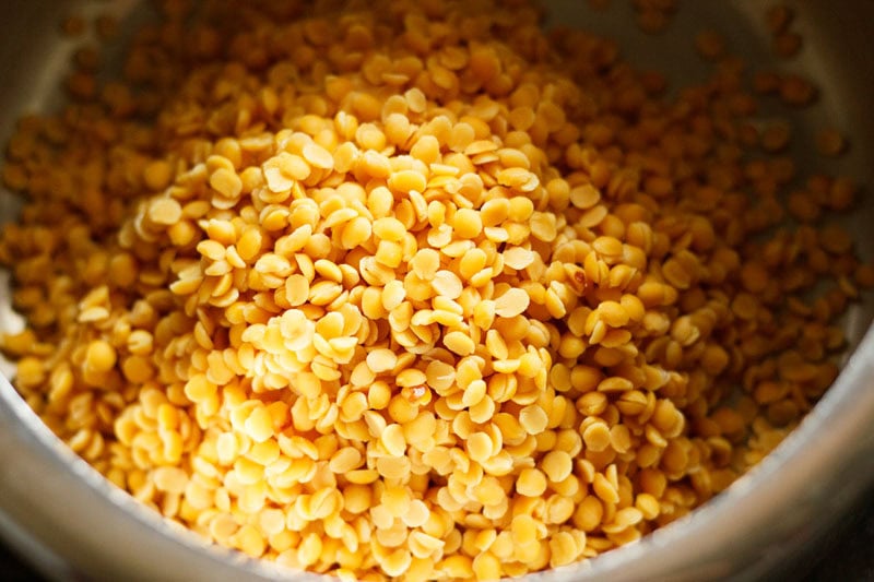 rinsed yellow lentils added in a stove pressure cooker.