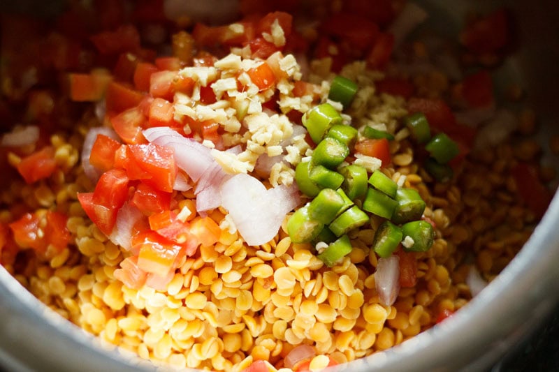 chopped onions, ginger, tomatoes and green chillies added to the lentils in the pressure cooker.