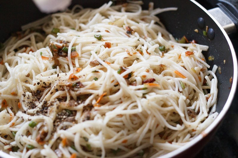 salt, crushed black pepper and vinegar added to hakka noodles.