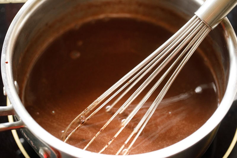 mixing chocolate chips with a whisk in the wet mixture.