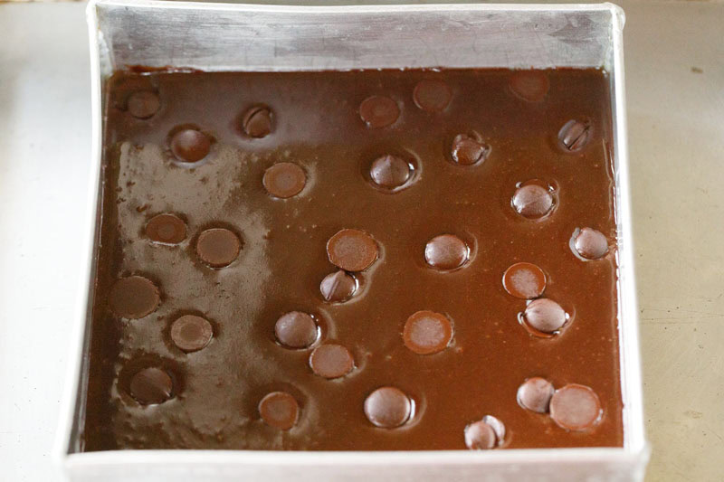 chocolate chips placed on batter in the baking pan.